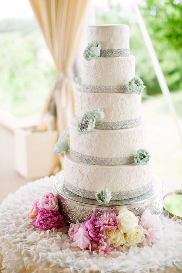 Stunning tiered wedding cake with gray trim and teal flowers - Photo by Dan Stewart Photography